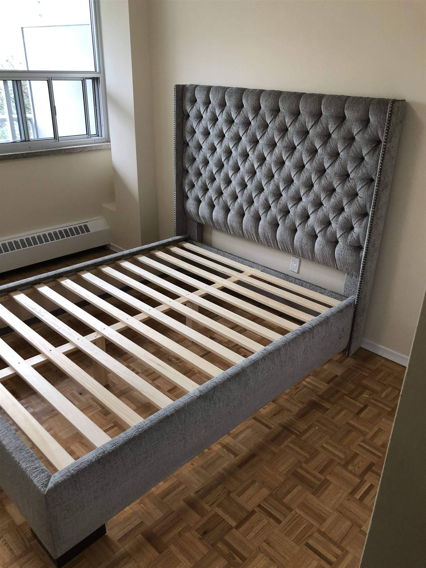 Grey tufted wingback bed