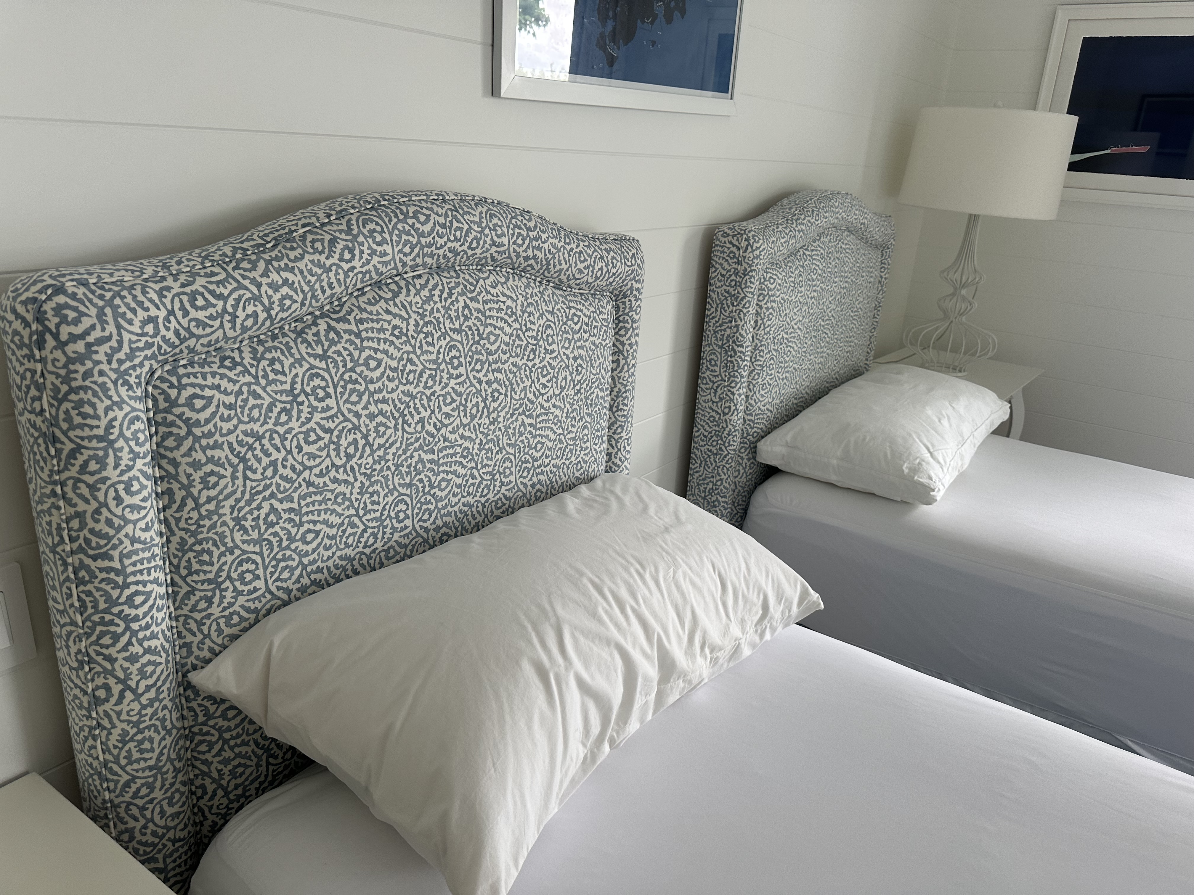 Custom blue and white patterned twin headboards with camelback arch and wingback sides