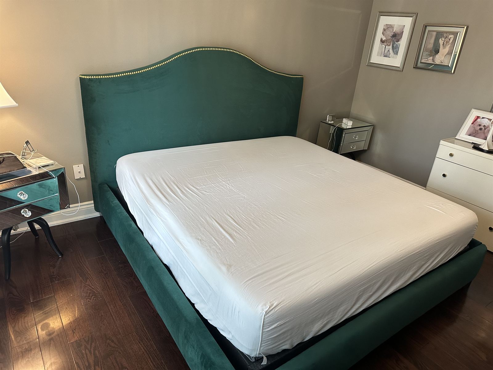 Custom emerald green velvet upholstered bed with gold nailhead trim
