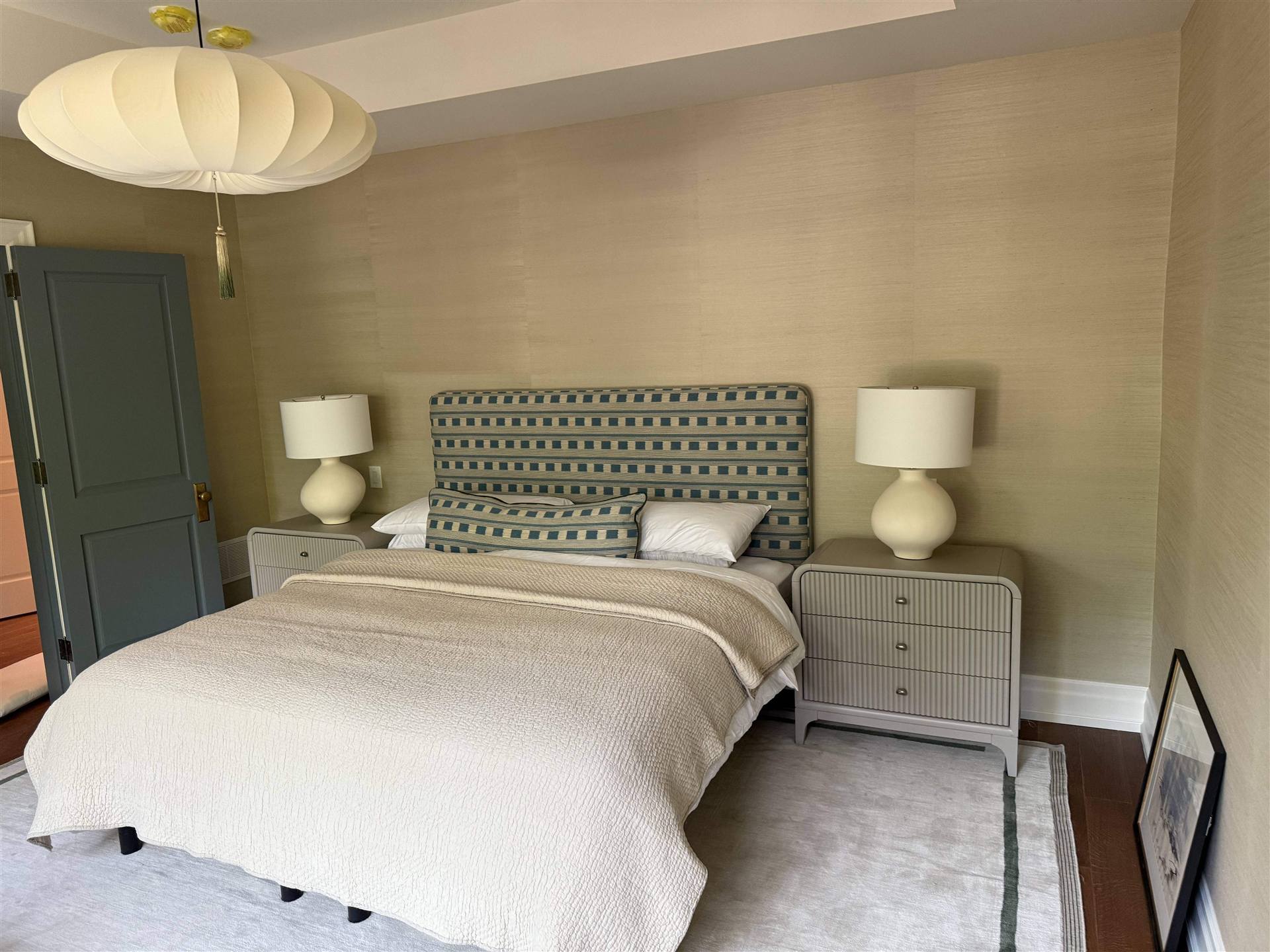 Custom geometric patterned teal and navy headboard in styled bedroom